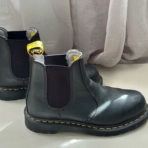 Dr. Martens steel toe boots.